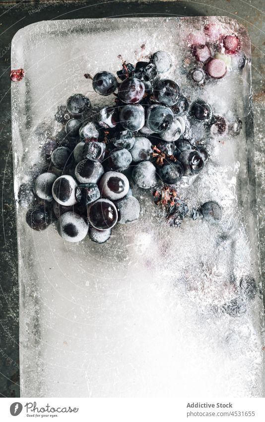 Ice with ripe grapes on metal tray ice berry frozen fruit cold freeze vitamin winery sweet sunlight food tasty piece crystal table delicious healthy food clear