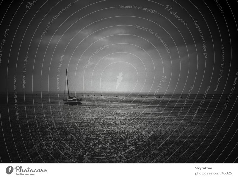 solitariness Watercraft Sailboat Ocean Black White Gray Calm Mud flats North Sea Sand lonely Empty Free