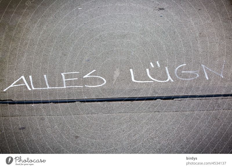 " All Lies " Writing with Spelling Disorder on a Sidewalk All lies spelling weakness writing Conspiracy theory Deniers deny Corona denier opponent