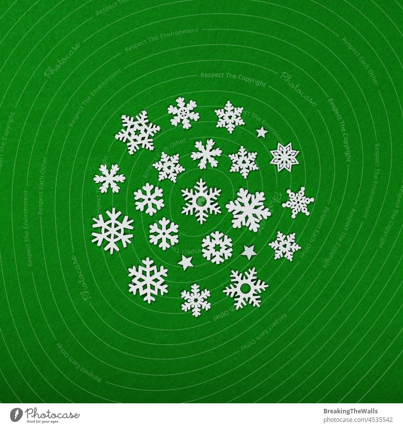 White snowflakes Christmas decoration white background pattern wooden felt green vivid new year winter holiday festive celebration celebrate decorate ornate