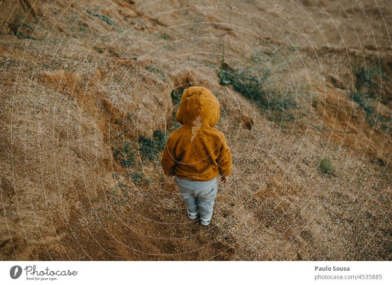 Rear view child with orange hoodie Child 1 - 3 years explore Colour photo Exterior shot Nature Playing Authentic Joy childhood Caucasian Life Happiness Day