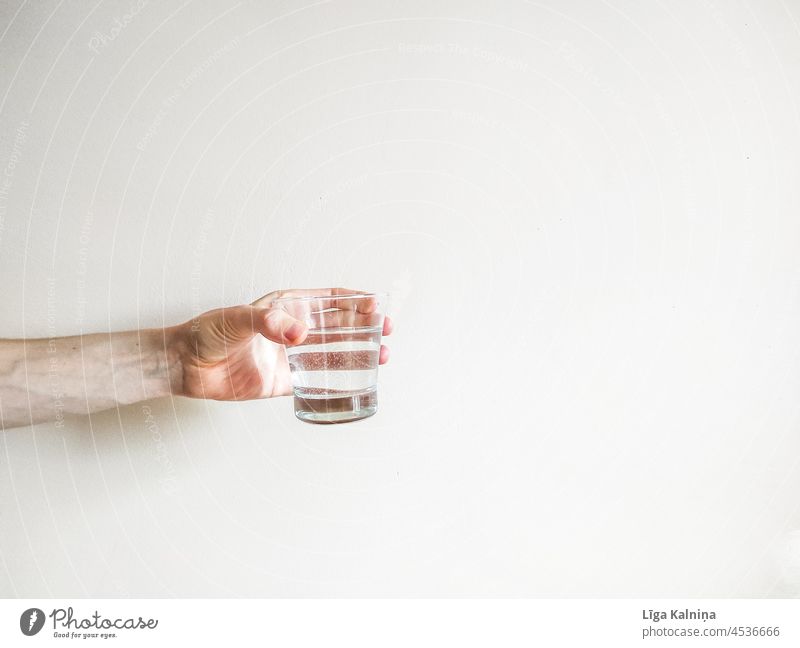 Hand holding a water glass with negative space Minimalistic background minimalism Simple Gray White body part Fingers wrist Arm Human being Palm of the hand