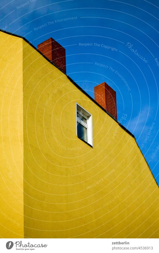 Yellow gable with one window and two chimneys Old building on the outside Fire wall Facade Window House (Residential Structure) Sky Sky blue rear building