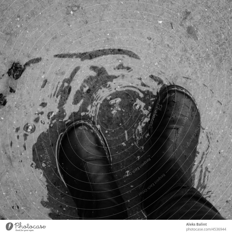 Standing in a puddle in boots Puddle Boots Exterior shot Wet Bad weather Rain Weather Reflection Water Autumn Black & white photo black-and-white