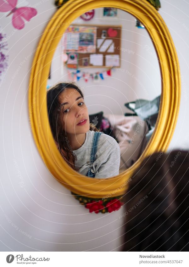 Reflection of a teenage girl in a mirror bedroom teenager beautiful hair reflection young female cute beauty image pink round care face cosmetic skin looking