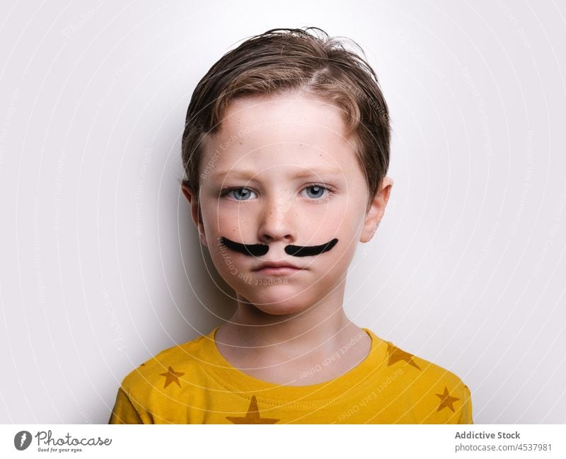 Boy with mustache in studio boy kid style pretend childhood playful outfit wow bright adorable apparel cute creative reaction garment wonder fantasy attire