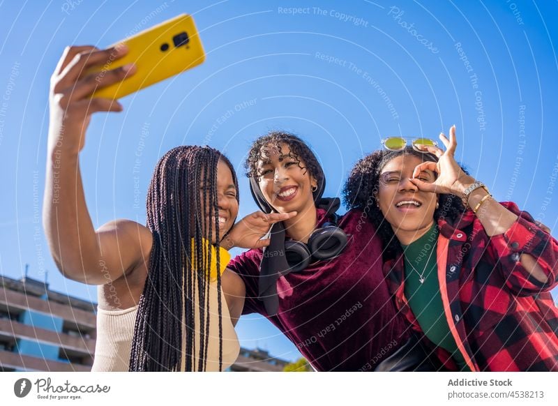 Happy black women taking selfie on street friend self portrait smartphone city photography spend time leisure capture friendship bonding group green summer