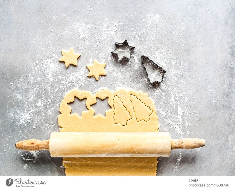 Ein ausgerollter Keksteig auf einem grauen Tisch Weihnachten backen Advent Christmas & Advent roh Nudelholz Tradition Ausstechform süß draufsicht Winter