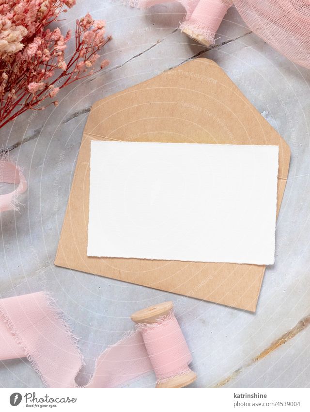 Card with envelope on table with pink flowers and ribbons Paper blank Pink Flowers Mock up Wedding silk Top view Romantic Light Pink pastel Marriage Nobody