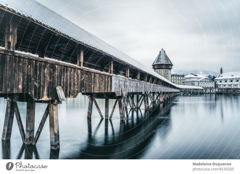 Chapel bridge with the water tower in Lucerne Switzerland Europe Kapellbridge Water tower reuss Winter Snow