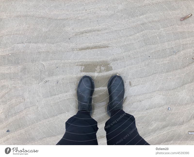 With the shoes on the wet sand Langeoog Footwear Boots Sandy beach Wet Nature Exterior shot Colour photo Human being North Sea Island Vacation & Travel