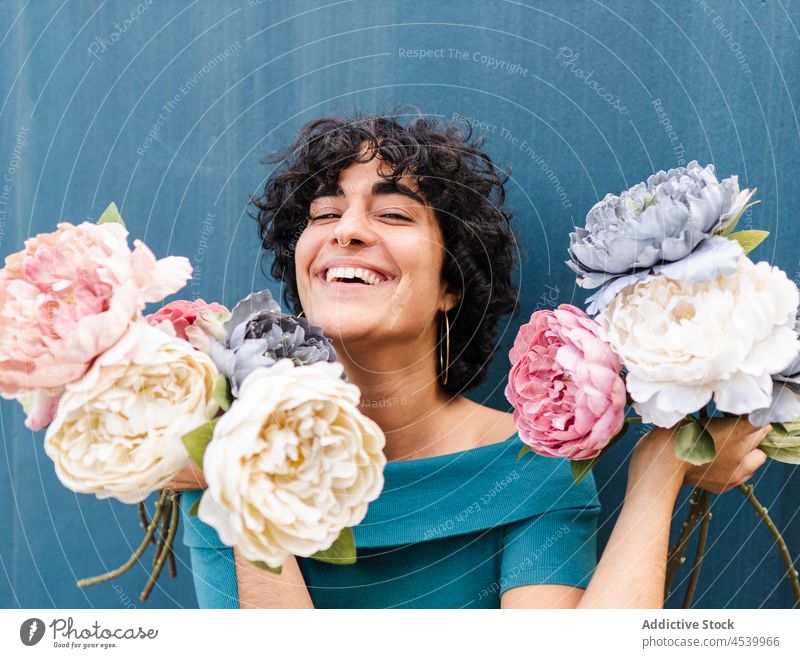 Happy woman with lush blooming peonies flower laugh peony bouquet happy charming fragrant female blossom optimist carefree glad delight positive toothy smile
