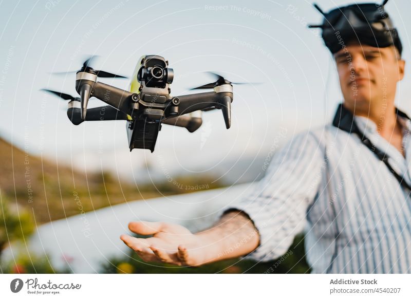 Man in VR goggles controlling drone man vr headset virtual reality unmanned immerse technology uav experience cyberspace innovation controller male modern