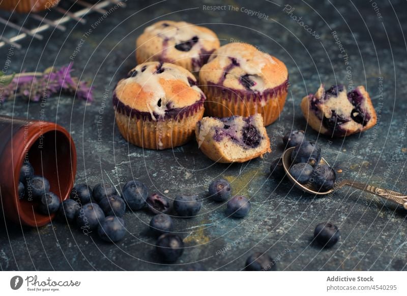 Delicious baked blueberry muffins with cream on table homemade sweet composition dessert treat delicious food spoon tasty yummy cuisine nutrition mint pastry