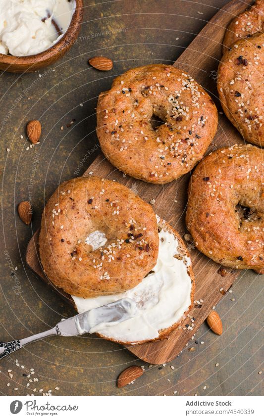 Delicious healthy bagels with sesame seeds baked healthy food weight loss diet culinary homemade cream cheese knife table kitchen cuisine nutrition product