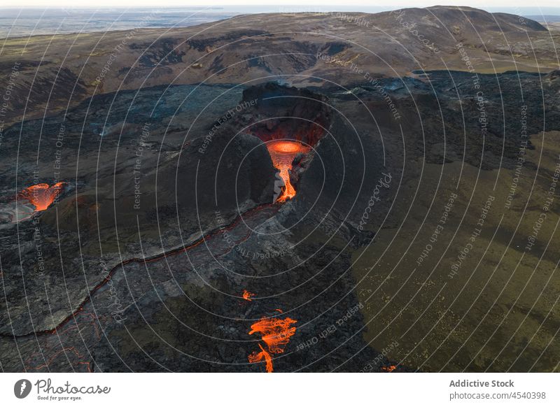 Volcano with lava in highlands volcano magma ash hill nature erupt crater active wild environment hot formation heat volcanic terrain surface light scene