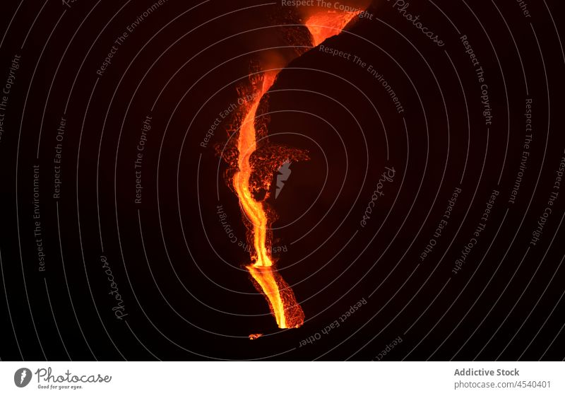 Bright orange lava emitting out of volcano at night erupt disaster nature mountain crater danger power devastate island motion cumbre vieja la palma