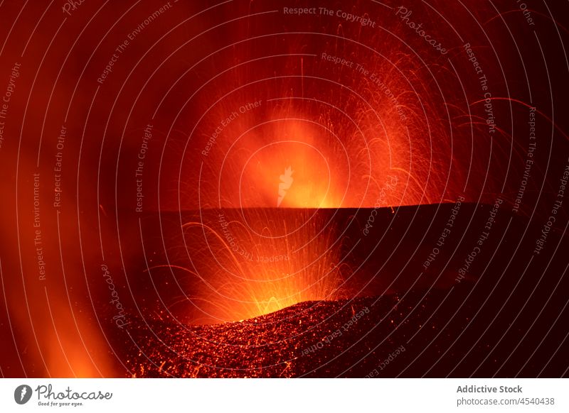 Bright orange lava emitting out of volcano at night erupt disaster nature mountain crater danger power devastate island motion cumbre vieja la palma