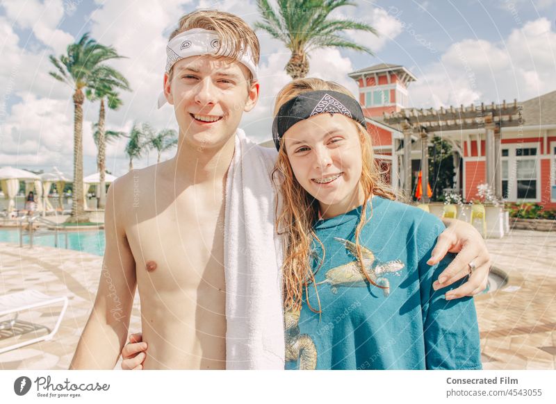 Boy and girl with bandanas side hugging at the pool with palm trees Vintage boho people Beautiful Beach Beauty Photography Summer Joy family boy florida