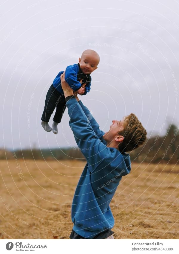 Man lifting up baby in the air with joy, in the country Country Baby Infant Newborn Boy Baby boy travel adventure smile laughing happy love faith laughter cute