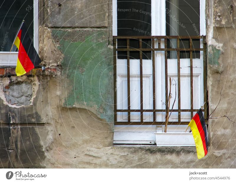 German flags on crumbling facade Facade Window Old building Weathered Ravages of time Change Germany Authentic Prenzlauer Berg Berlin repaired Art nouveau house