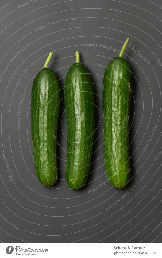 three cucumbers on black background Vegetable Lettuce Cucumber Snake Cucumber threesome in a threesome Harvest harvest garden Field organic Food Healthy Fresh