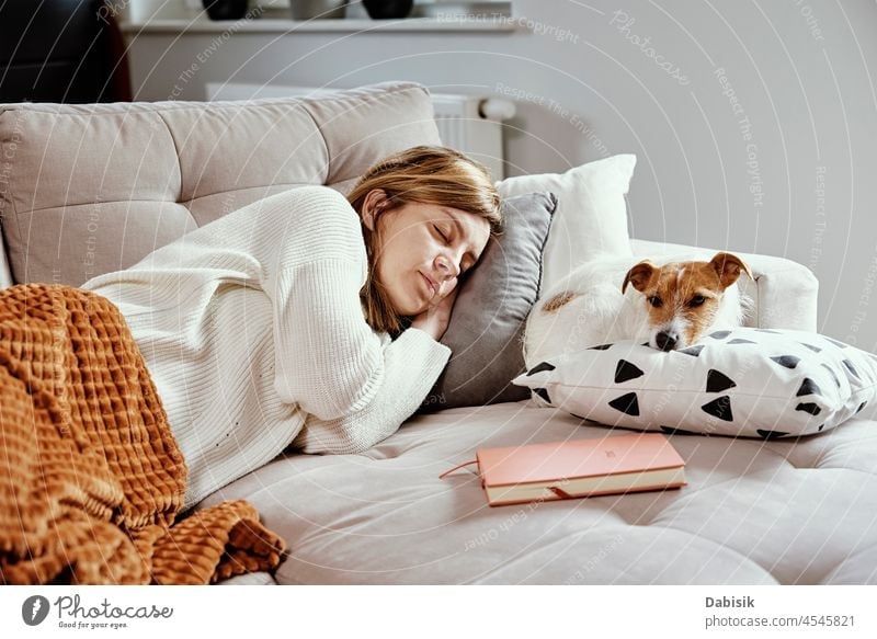 Woman sleep with dog on sofa pet woman animal bed friendship rest caucasian lifestyle beautiful cute female companion tired relaxation dream lying pretty