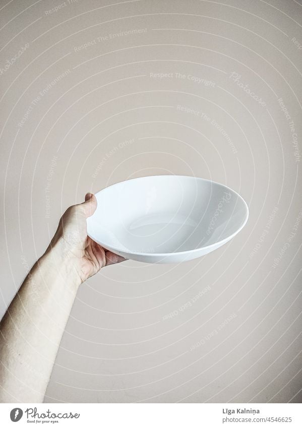 Hand holding a white empty plate Plate Edge of a plate Food photograph Copy Space top Detail Interior shot