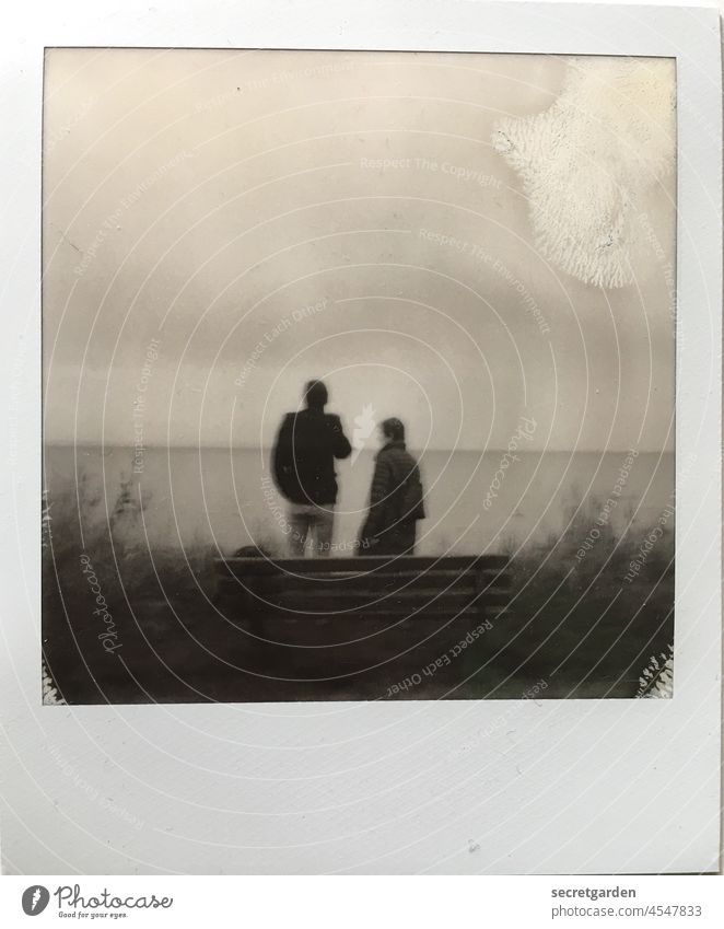 The two, a bench and the sea. Polaroid Analog Ocean gape Mother Son Mother's Day Gloomy Bench Winter Cold Minimalistic Horizon Frame blotch Fog Loneliness