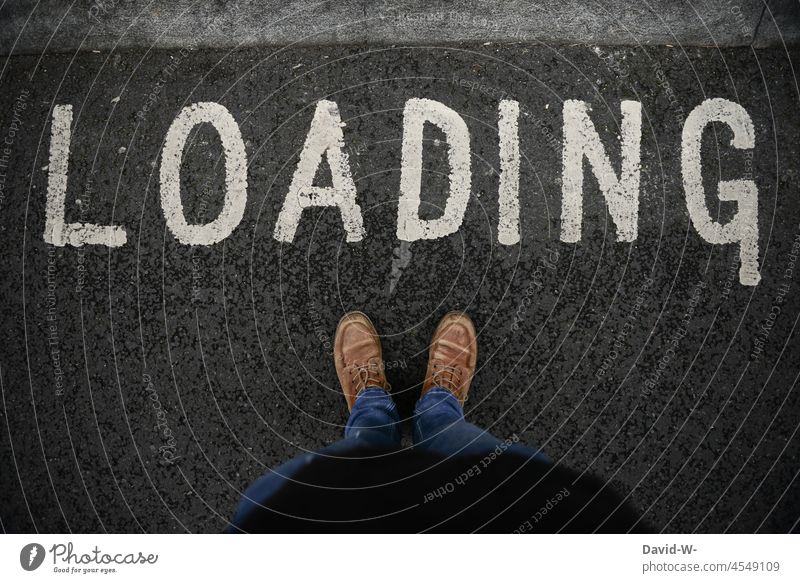 loading - it loads - wait for something Load invites Wait impatiently Word concept feet Text Stand waiting time