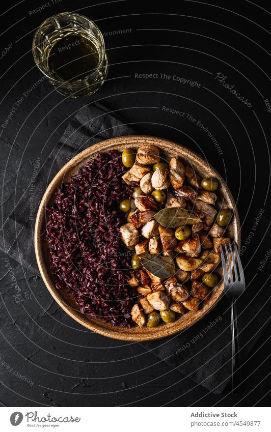 Plate with sauteed turkey with olives placed on black table restaurant delicious beverage drink plate glass tasty food dish portion meal serve gourmet fresh