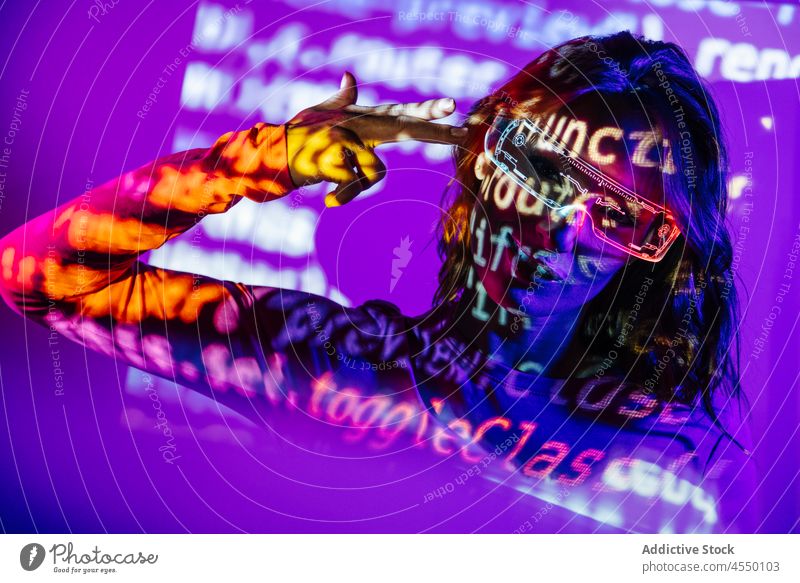 Stylish Young Woman In projector Lights with html code hacker programmer computing online suicide gun shot colorful security led glasses confident bright
