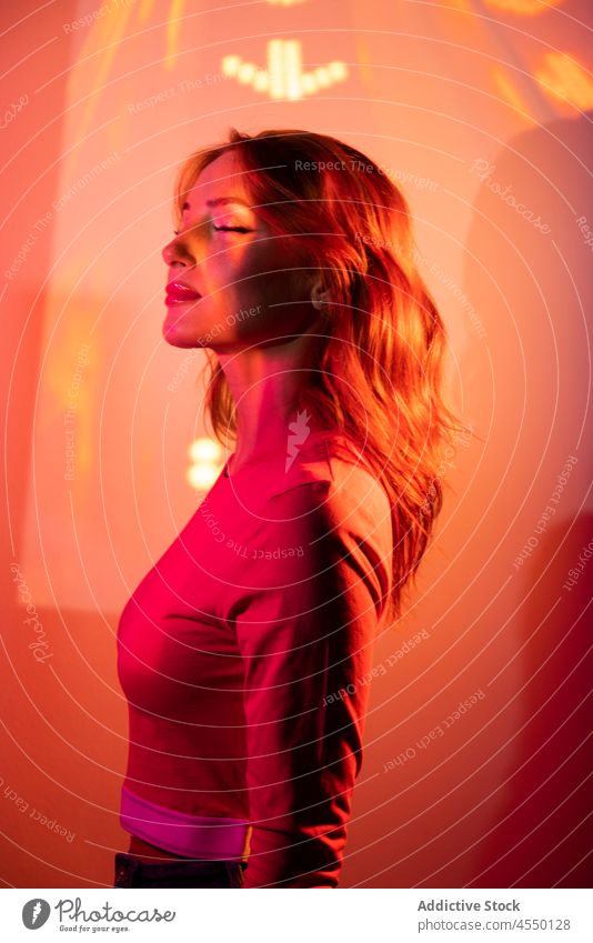 Creative Portrait Of Ginger Woman With Orange Led Lights weird blurred attractive bright long exposure creative calm casual charming color colorful cool dreamy