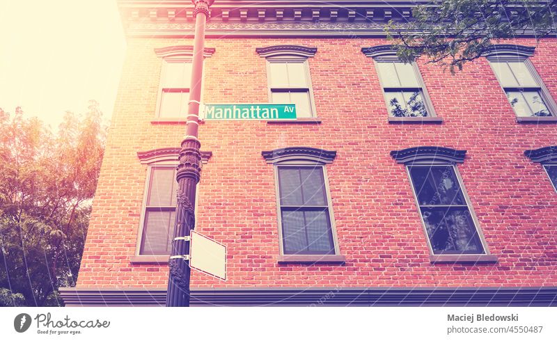 Old brick building with Manhattan Avenue sign, color toning applied, New York City, USA. city townhouse retro toned sun traffic sign old NYC travel destination