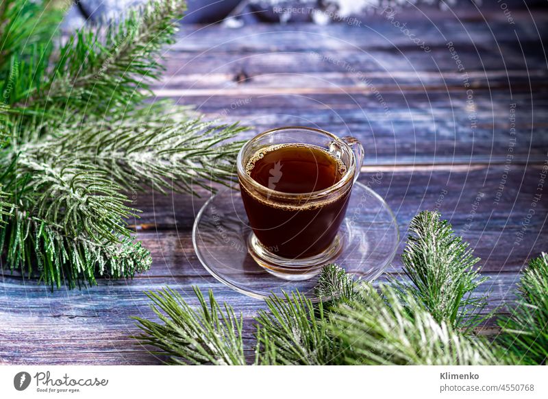 A cup of aromatic coffee with brown sugar, Christmas decorations, branches of a Christmas tree. Holiday concept New Year. On a wooden background. new year