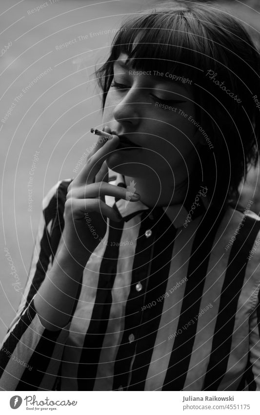 young woman smoking in black white Smoke Cigarette Smoking portrait Woman Unhealthy Harmful to health Health hazard Dependence Addiction Nicotine Nicotine odour