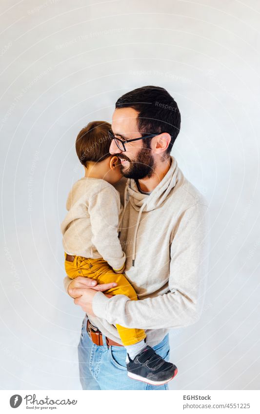 Young dad with his son in arms on white background. Father and baby concept. father holding latin happy man isolated adorable hispanic beautiful boy cheerful