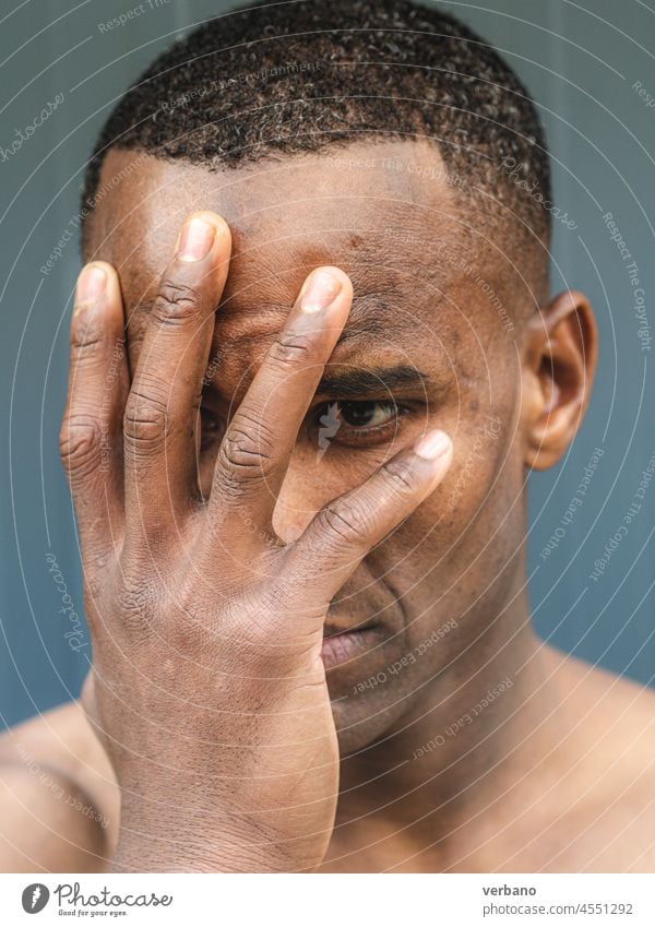 portrait of an young topless fit african male model afro american man expression shirtless hands muscular muscled emotion posing grey background body handsome