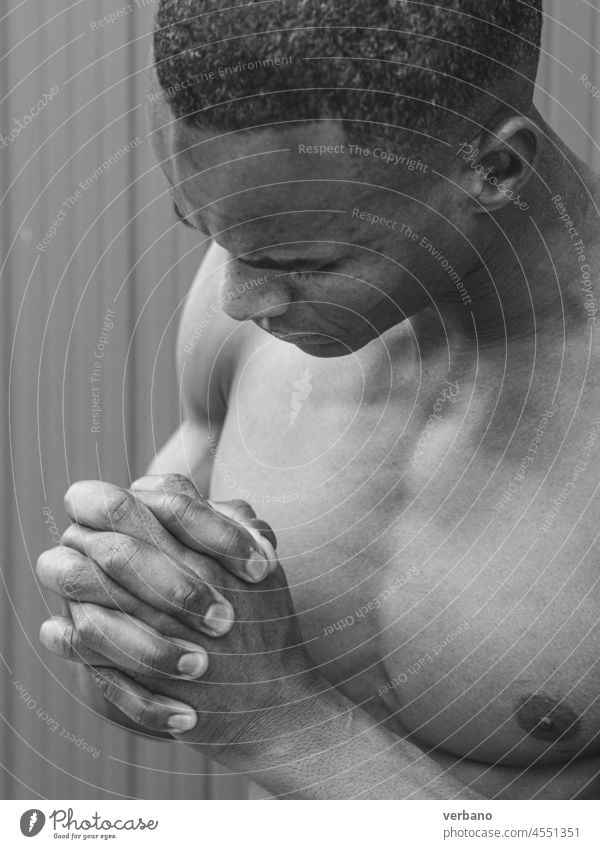 bw portrait of an young topless athetic african man afro american male expression shirtless hands muscular muscled emotion posing model grey background body