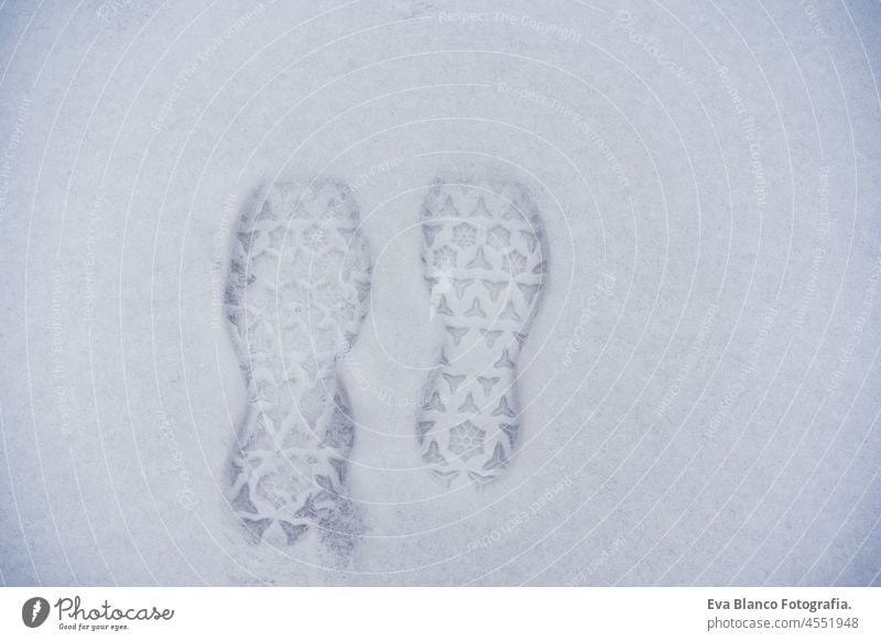 footprints on snow during winter season, nobody, travel and hiking concept foot mark boots mountain walking minimal white direction nature step frost background