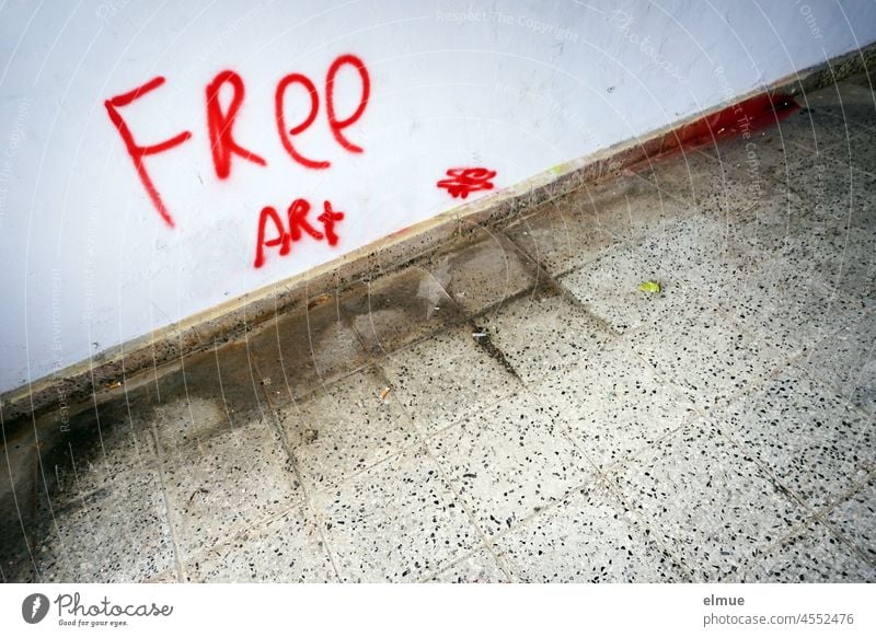 FREE ART was sprayed in red on the wall of a passage / art / graffito free art English Free Art manner demand Wall (building) Passage Graffito Graffiti Red