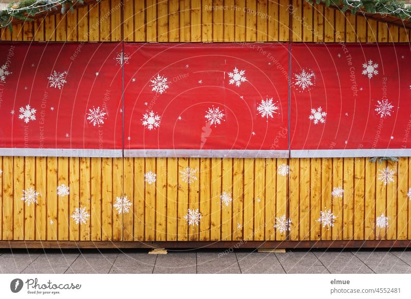 closed wooden christmas stall with red curtain and sprayed on big white snowflakes / anticipation / corona ordinance sales booth Christmas booth Anticipation