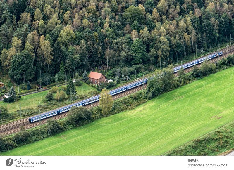 View from above on a railway line with passenger train Landscape Railroad Train Track Deserted Grass Meadow Forest Nature Elbe valley