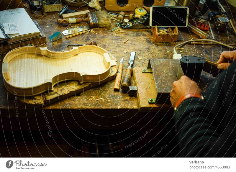 violinmaker working in his desk  bending the c ribs of a violin luthier wood cremona body craftsman violin maker craftsmanship violin making tools skill