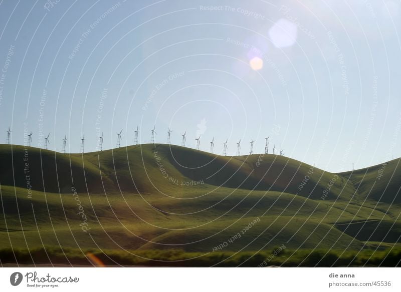 landscape with windmills Meadow Hill Green Grass Mountain Wind energy plant Sun Blue sky Nature