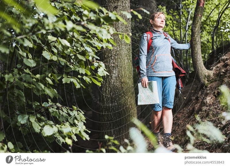 Active woman walking on forest path, actively spending summer vacation trip travel journey adventure activity backpack fun trekking female wanderlust hiking