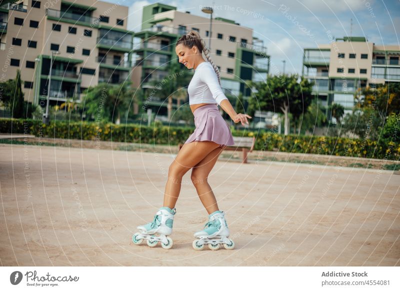 Woman skating in the square of a housing development. woman roller skate street sportive hobby sidewalk activity training wellbeing healthy lifestyle female