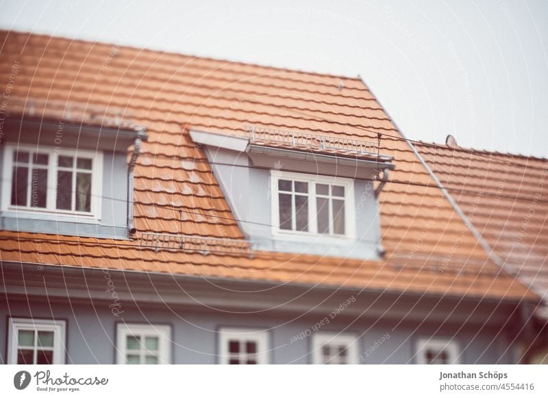 Skylight on roof with red tiles Roof Roofing tile Red House (Residential Structure) dwell Rent Rental prices Winter Cold Apartment house Old building Window