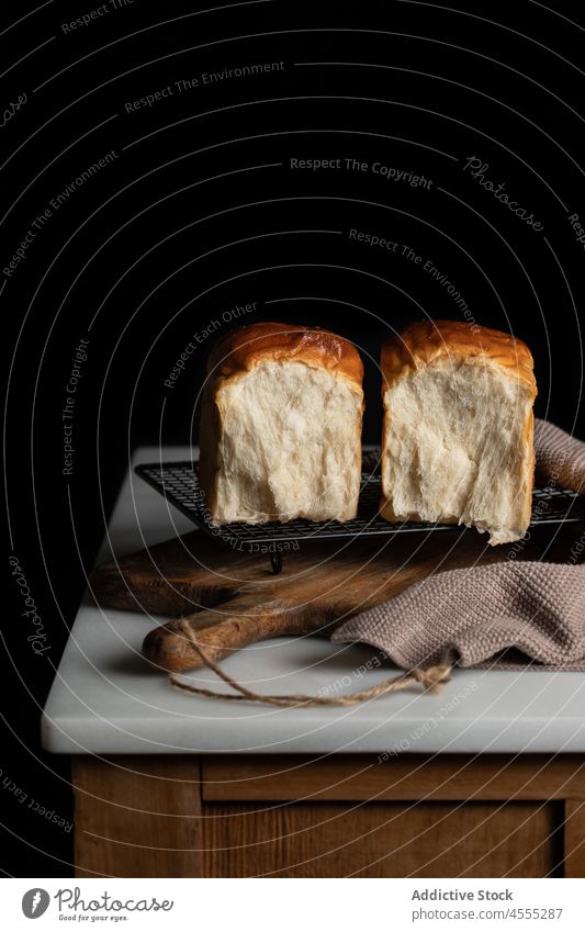Halves of sandwich bread in dark room half split tasty baked delicious food loaf appetizing grill yummy nutrition tray counter delectable fresh piece nutrient