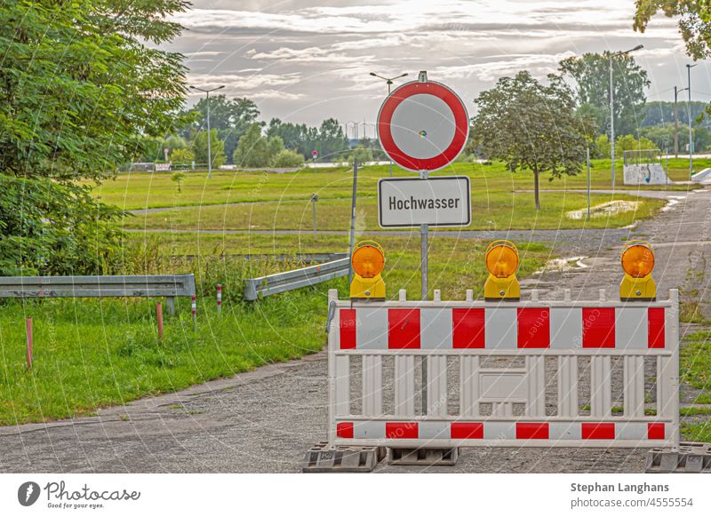 Picture of a flood barrier during a flood on the river Rhine water flooding street rain plate danger warning signs disaster weather flux climate nature stop